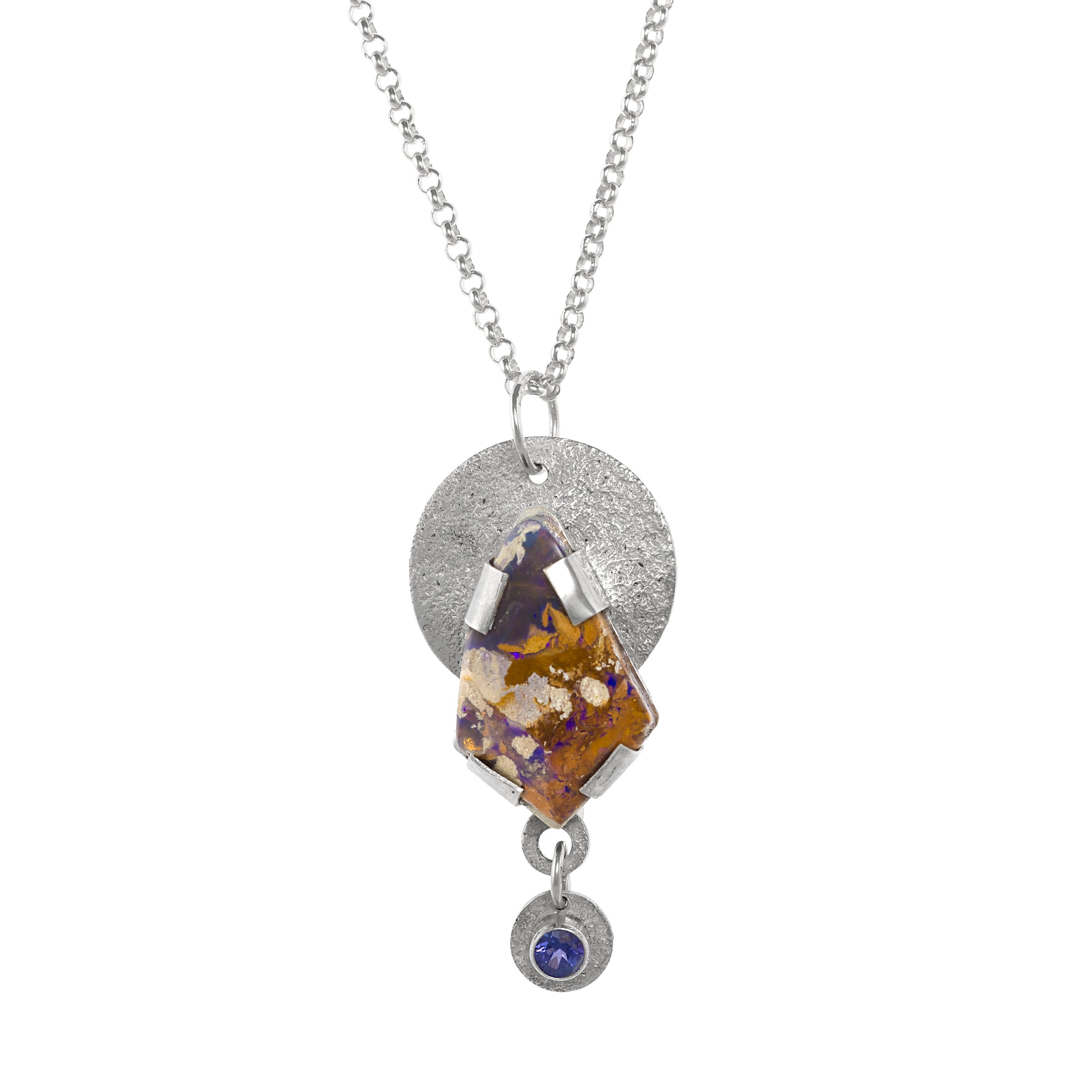 Hand fabricated, sterling silver pendant necklace featuring an 18x28mm boulder opal of purple, chocolate, copper and cream with a 5mm tanzanite highlighting the purple shades. 