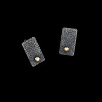 Rectangular post earrings, hand fabricated from textured and oxidized sterling silver with 14k gold elements.