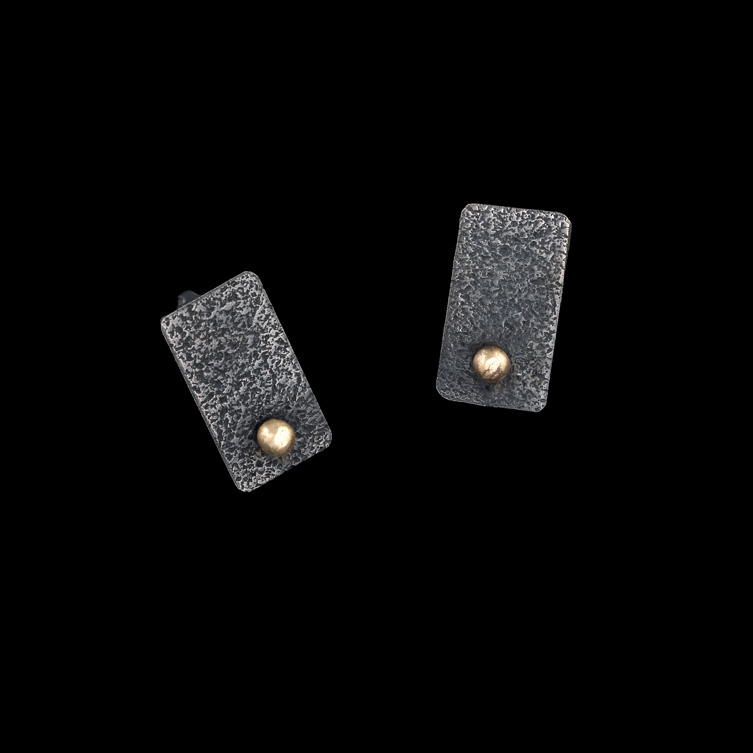 Rectangular post earrings, hand fabricated from textured and oxidized sterling silver with 14k gold elements.