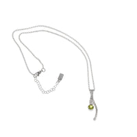 Handcrafted, one-of-a-kind pendant necklace featuring an organic casting of a twig in sterling silver, highlighted by a 6mm green peridot.