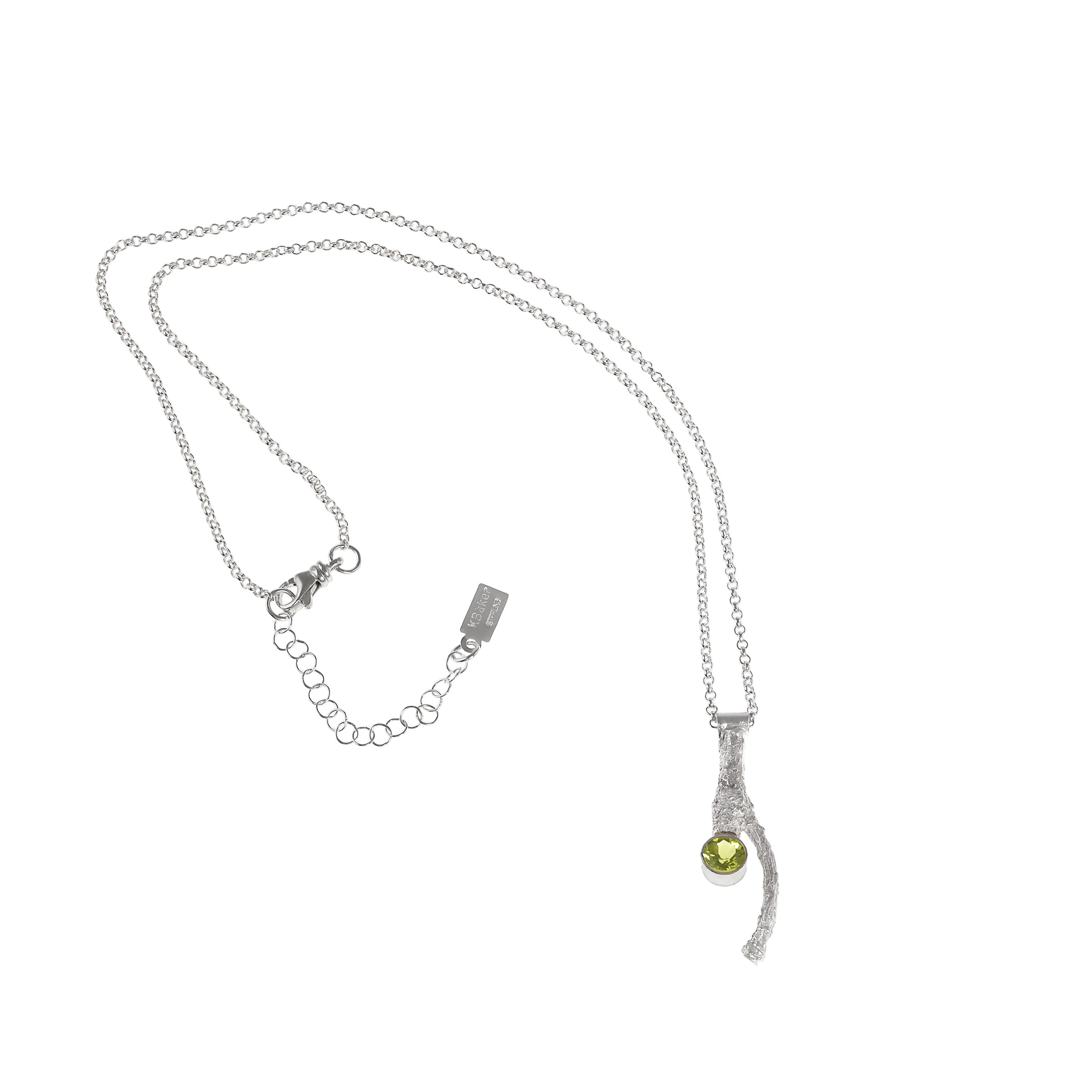Handcrafted, one-of-a-kind pendant necklace featuring an organic casting of a twig in sterling silver, highlighted by a 6mm green peridot.