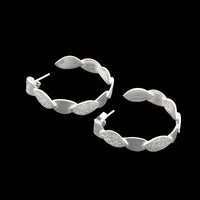 Hand-fabricated, sterling silver post hoops of textured and shiny leaves.