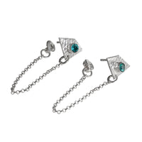 Handcrafted, sterling silver post earrings featuring teal topaz gemstones and dangling silver chains.