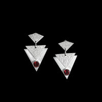 Contemporary, geometric design post earrings, hand-fabricated in sterling silver and featuring deep red garnets.