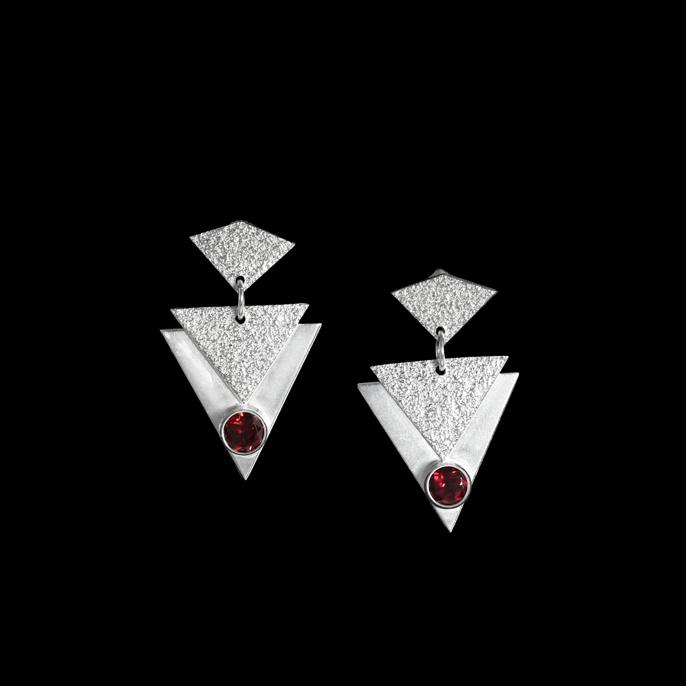 Contemporary, geometric design post earrings, hand-fabricated in sterling silver and featuring deep red garnets.