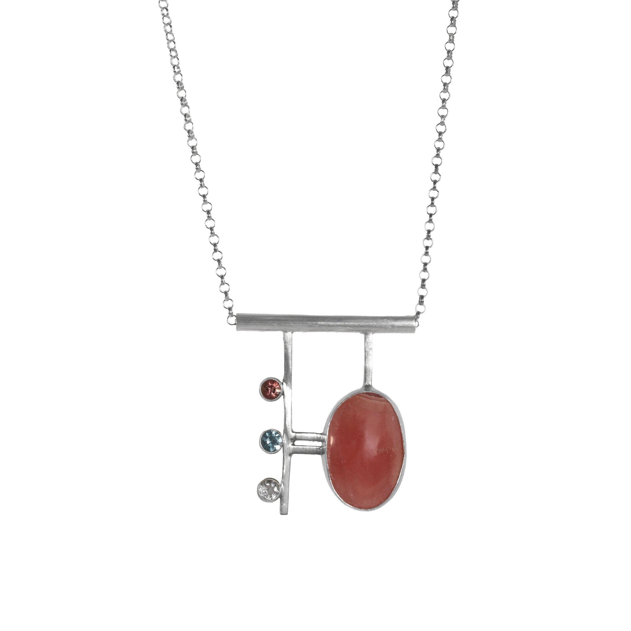 Contemporary, geometric design pendant necklace, hand-fabricated from sterling silver and featuring a large rhodochrosite cabochon highlighted with a pink tourmaline, blue zircon and white topaz.
