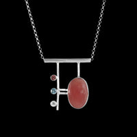 Contemporary, geometric design pendant necklace, hand-fabricated from sterling silver and featuring a large rhodochrosite cabochon highlighted with a pink tourmaline, blue zircon and white topaz.