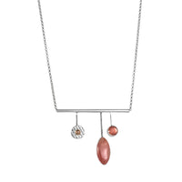 Handcrafted, contemporary pendant necklace in sterling silver and featuring a rhodochrosite cabochon, Oregon sunstone and 14K gold ball. 