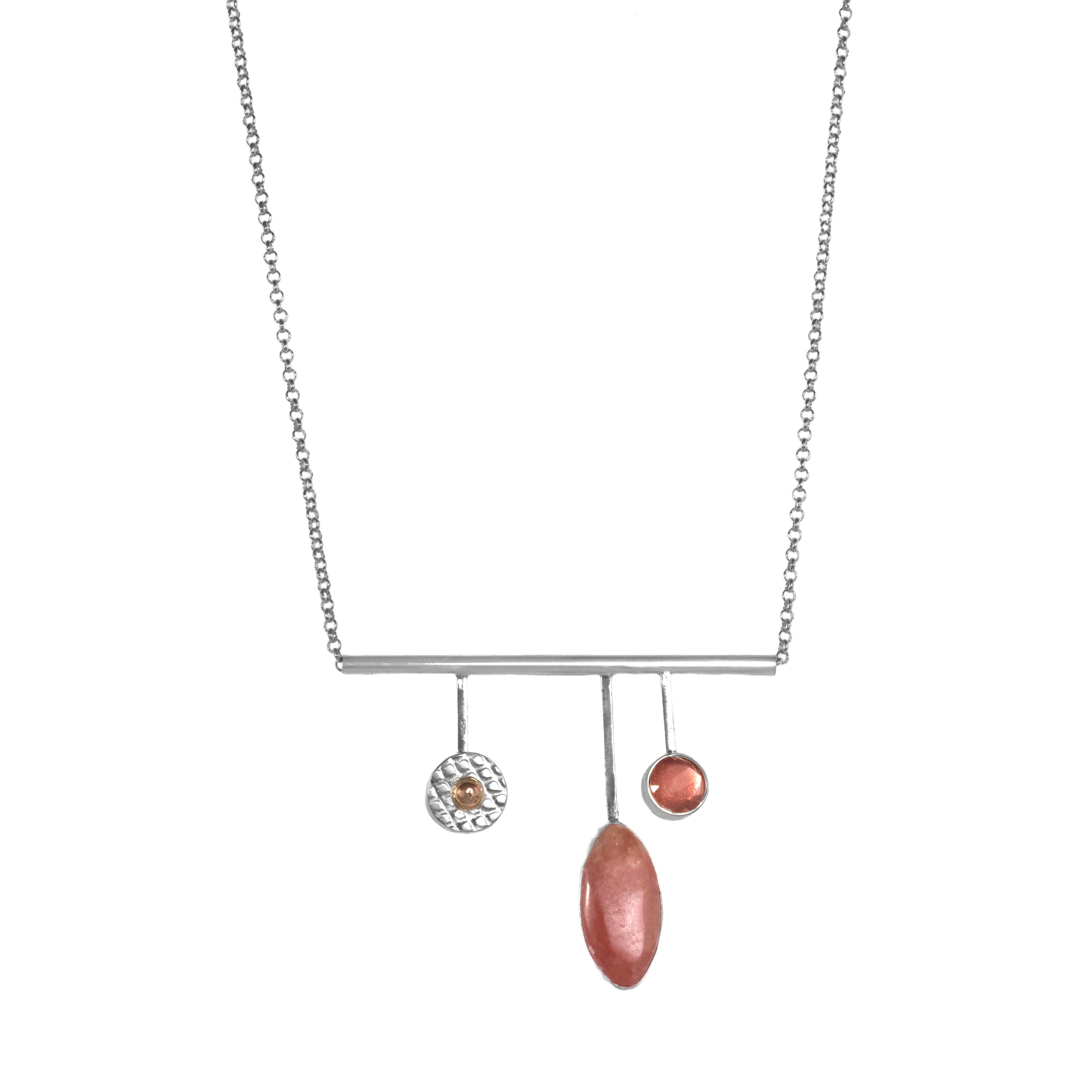 Handcrafted, contemporary pendant necklace in sterling silver and featuring a rhodochrosite cabochon, Oregon sunstone and 14K gold ball. 