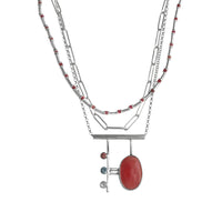 Contemporary, geometric design pendant necklace, hand-fabricated from sterling silver and featuring a large rhodochrosite cabochon highlighted with a pink tourmaline, blue zircon and white topaz.