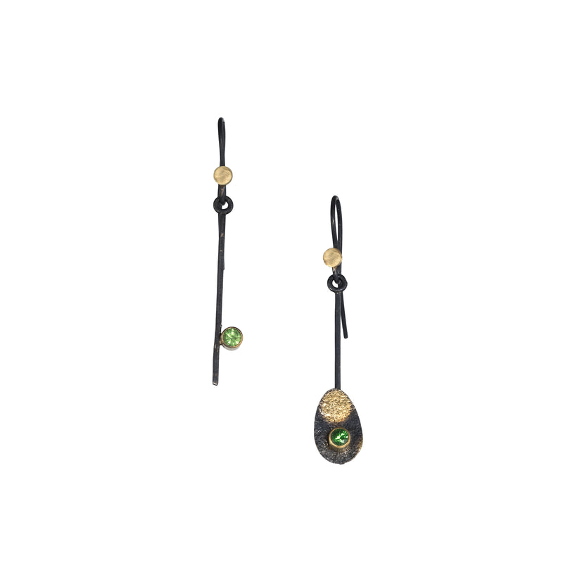 Contemporary, asymmetrical drop earrings, hand-fabricated in sterling silver with inlaid 18K gold and set with green Tsavorite garnets.