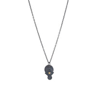 Oxidized argentium sterling silver and 18K gold charm pendant necklace with contemporary geometric styling in a layered look.