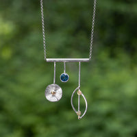 Sterling silver and 18K gold pendant necklace with London blue topaz (December birthstone) on sterling silver chain.