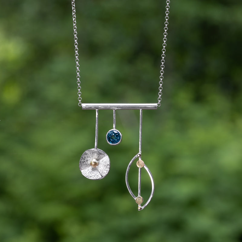 Sterling silver and 18K gold pendant necklace with London blue topaz (December birthstone) on sterling silver chain.