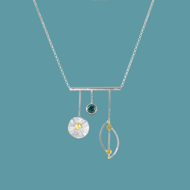 Sterling silver and 18K gold pendant necklace with London blue topaz (December birthstone) on sterling silver chain.