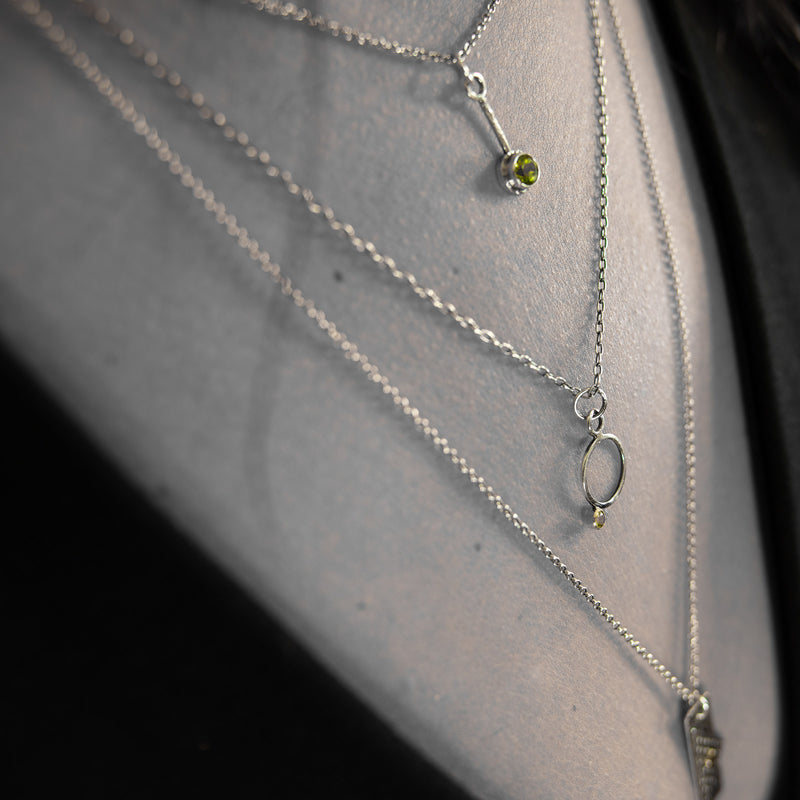 Oxidized argentium sterling silver and 18K gold charm pendant necklace with contemporary geometric styling.  Shown layered with other pendants.