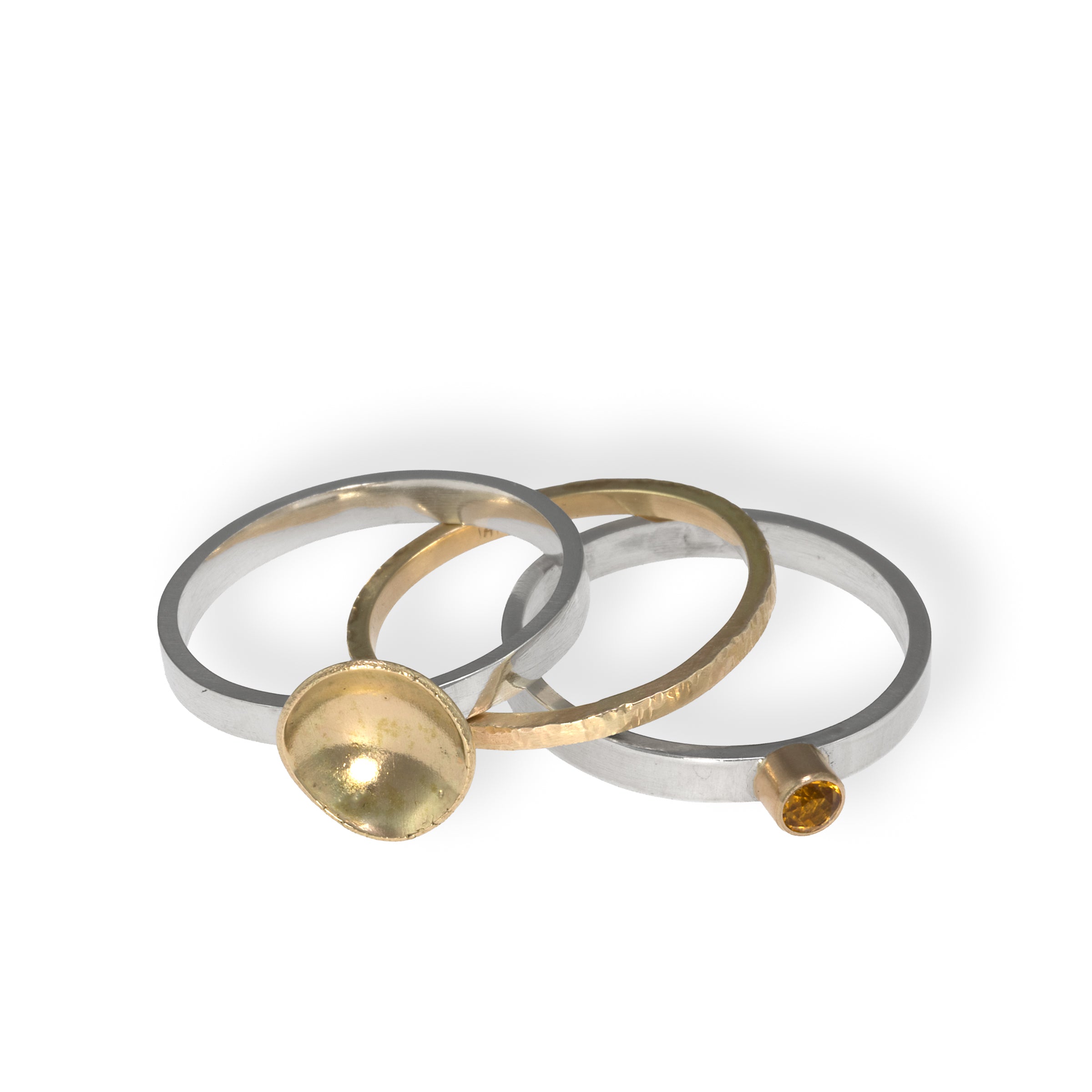 One-of-a-kind, three ring stacking set comprised of a sterling silver band with a 14k gold cup element, a 14k gold band, and a sterling silver band with an 8mm golden citrine set in 14k gold.  