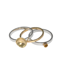 One-of-a-kind, three ring stacking set comprised of a sterling silver band with a 14k gold cup element, a 14k gold band, and a sterling silver band with an 8mm golden citrine set in 14k gold.  