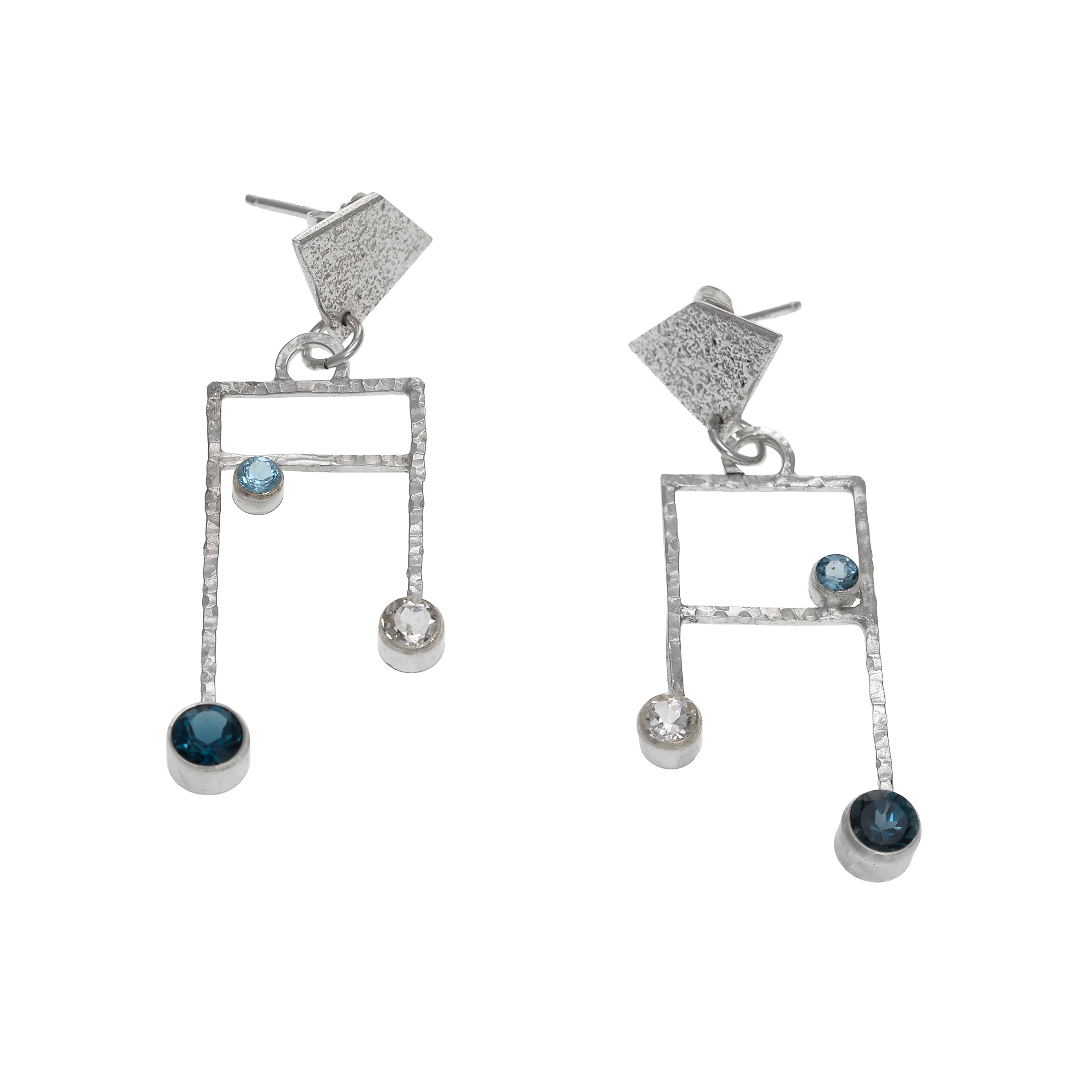 Contemporary post earrings, hand-fabricated in Argentium sterling silver and set with London Blue, Swiss Blue and white topaz.