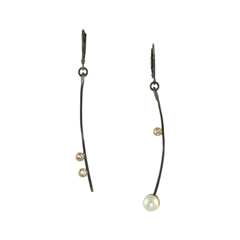 Asymmetric drop earrings handcrafted in oxidized Argentium sterling silver.  Set with three white topaz in 18K gold bezels and a freshwater pearl in an 18K gold cup.