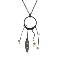 24” long pendant necklace handcrafted with oxidized Argentium sterling silver, 18K gold elements, two white topaz stones and a white freshwater pearl.