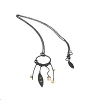 24” long pendant necklace handcrafted with oxidized Argentium sterling silver, 18K gold elements, two white topaz stones and a white freshwater pearl.