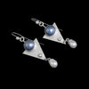 One-of-a-kind, dangle earrings in sterling silver featuring 10mm blue Mabe pearls, 4mm white topaz and 6mm white freshwater pearl drops.