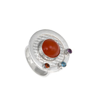 One-of-a-kind, statement ring in sterling silver with a 10mm orange chalcedony cabochon surrounded by three faceted stones – a fire citrine, London blue topaz and purple amethyst.  Size 8.
