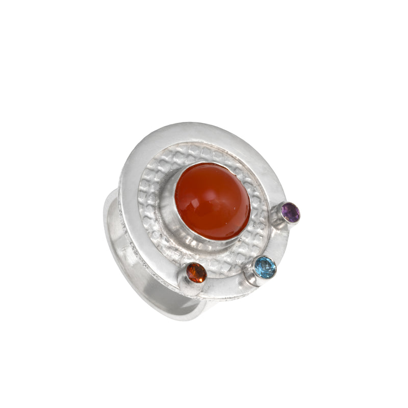 One-of-a-kind, statement ring in sterling silver with a 10mm orange chalcedony cabochon surrounded by three faceted stones – a fire citrine, London blue topaz and purple amethyst.  Size 8.