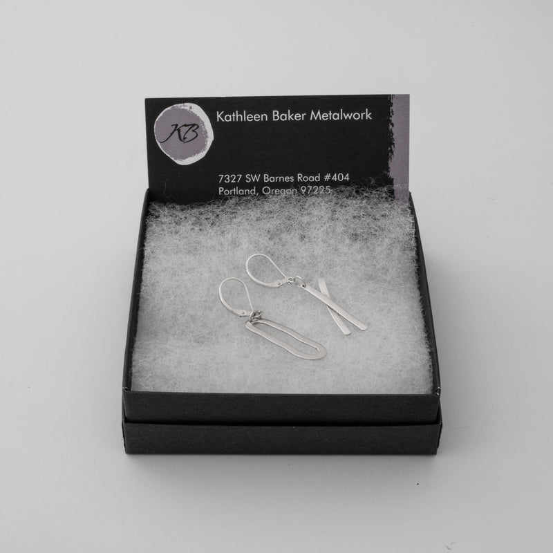 Asymmetrical, “exes and ohs” dangle earrings, handcrafted from textured Argentium silver with a sterling silver lever back.