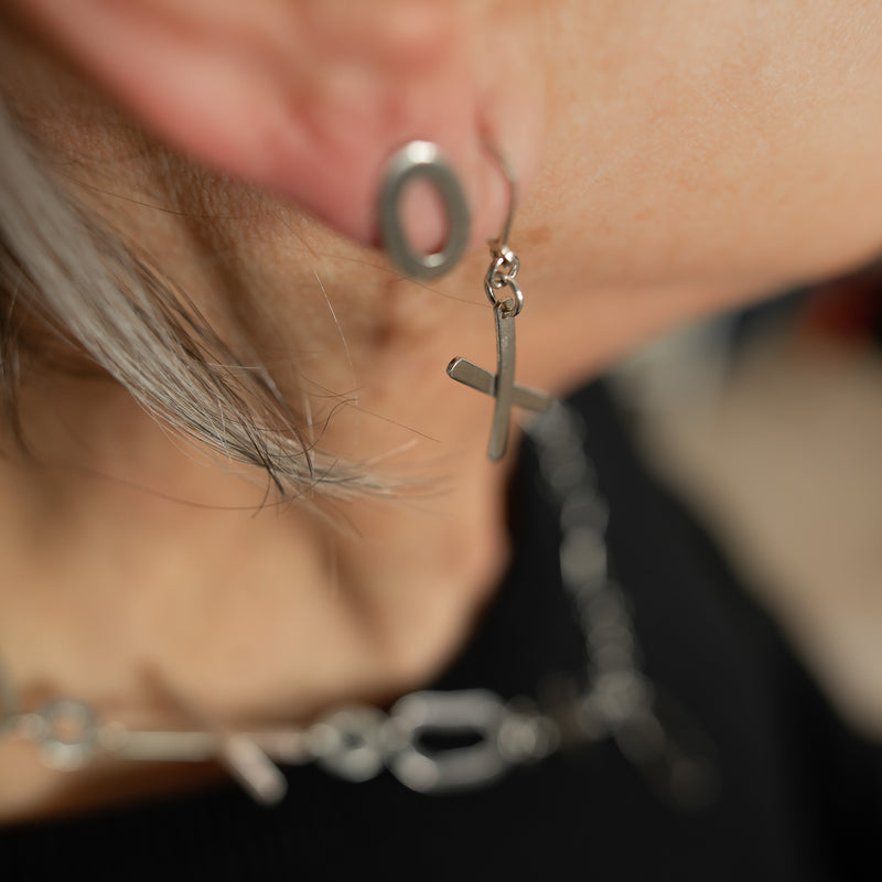 Asymmetrical, “exes and ohs” dangle and stud earrings, handcrafted from textured Argentium silver with a sterling silver back.