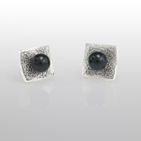 Hand-fabricated, post earrings in sterling silver with 6mm black pearls.