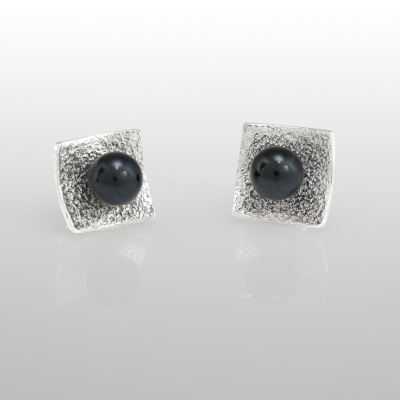 Hand-fabricated, post earrings in sterling silver with 6mm black pearls.