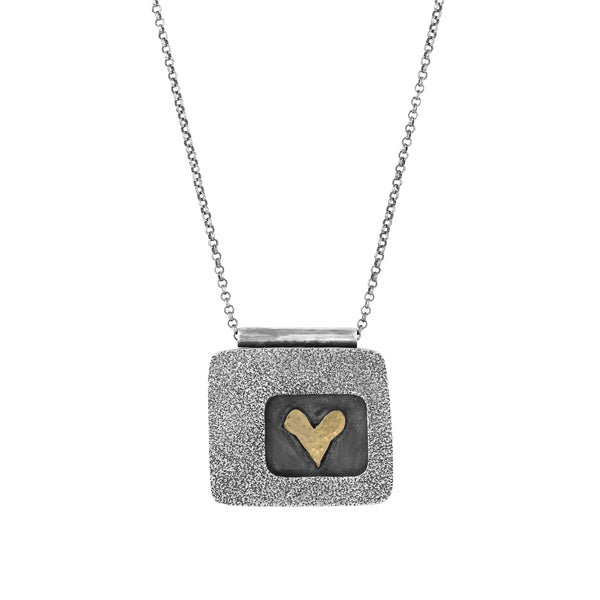 Rectangle hollow form oxidized sterling silver pendant necklace with an inset 14k yellow gold handmade heart. 18” sterling silver chain with an additional 2” extender.