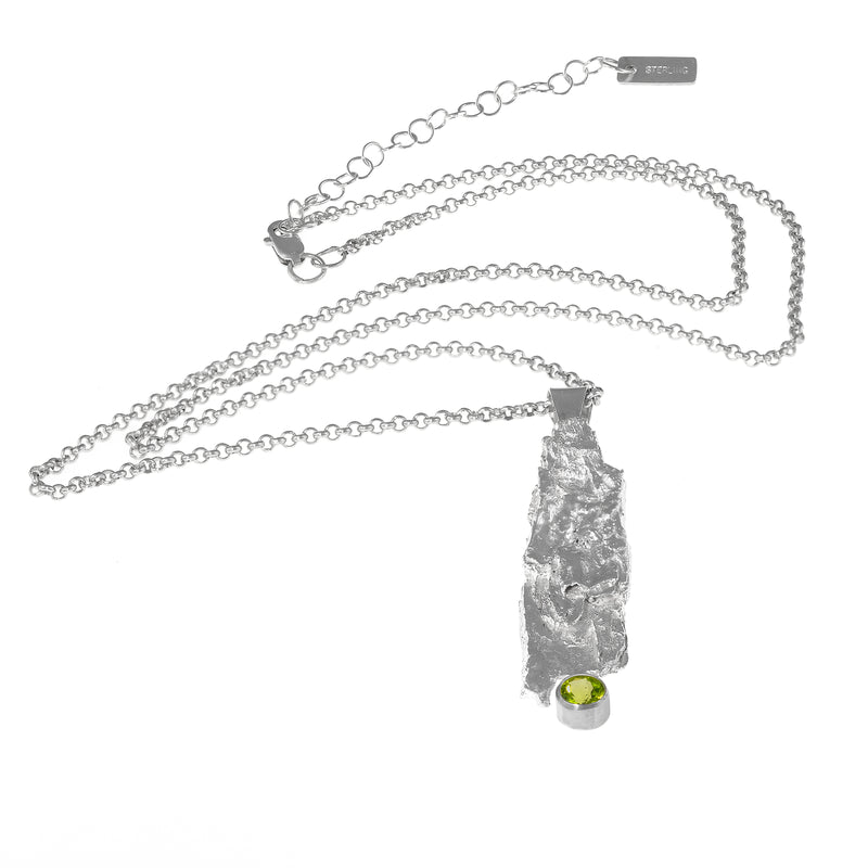 One-of-a-kind pendant necklace.  Handcrafted, organic casting of bark in sterling silver set with a bright green peridot (august birthstone) and hung on a silver rolo chain. 