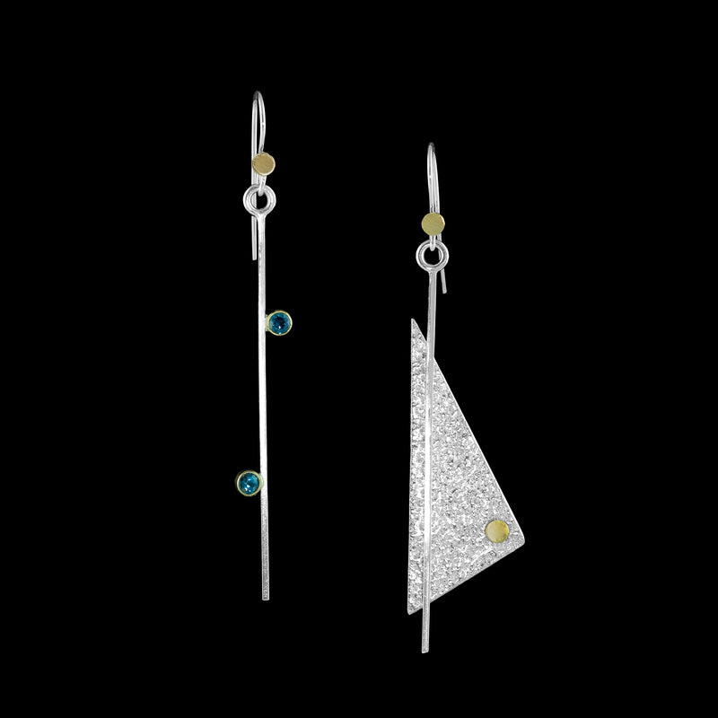 Asymmetrical dangle earrings, handcrafted in Argentium sterling silver with 18K gold accents and blue topaz gemstones set in 18K gold bezels.  December Birthstone.