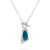 One-of-a-kind, lariat-style pendant necklace handcrafted in sterling silver around a stunning Ithaca Peak turquoise stone paired with a white sapphire.  Hand fabricated toggle clasp on a sterling silver oval chain.