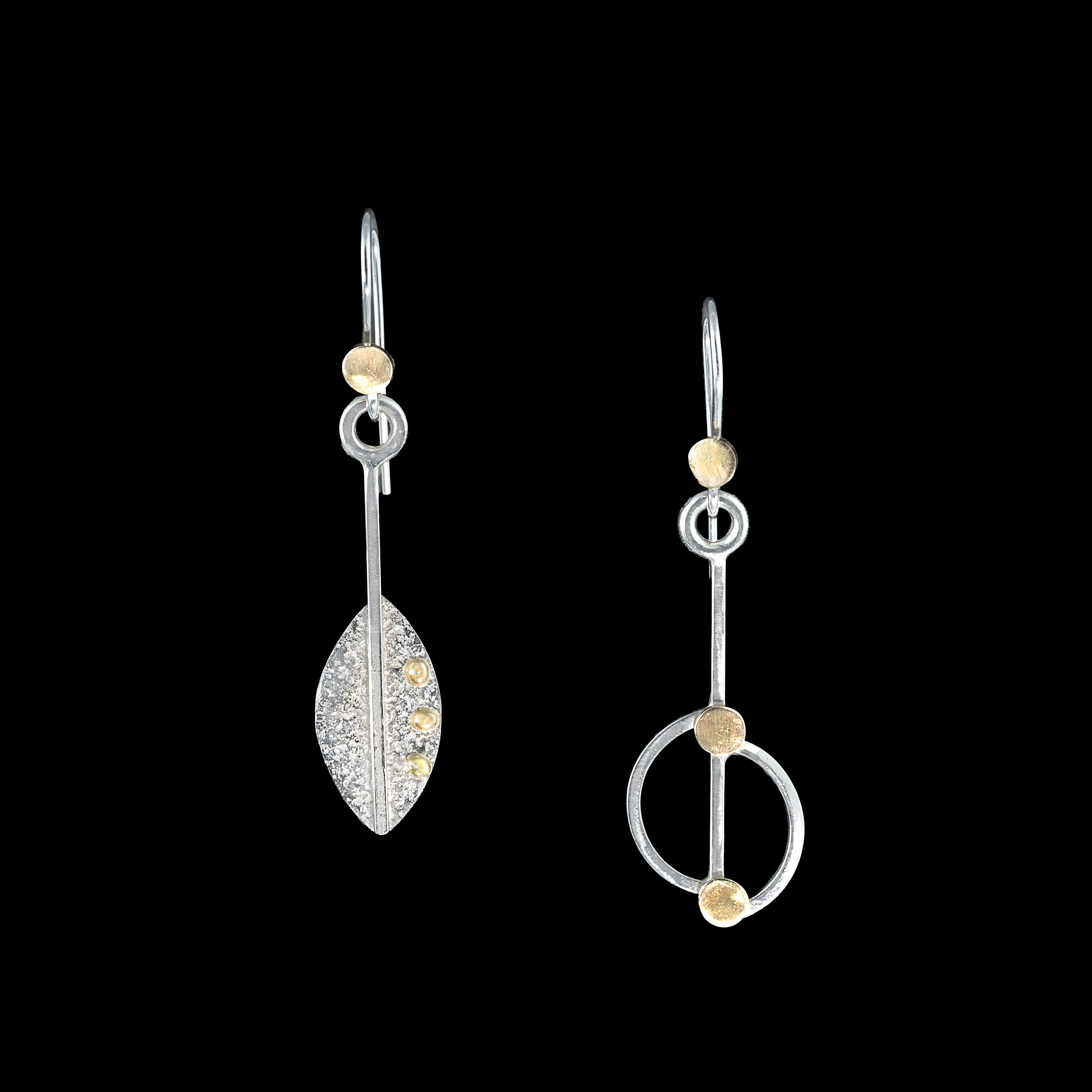 Asymmetrical, leaf-themed dangle earrings, hand-fabricated in sterling silver with 14k gold elements.