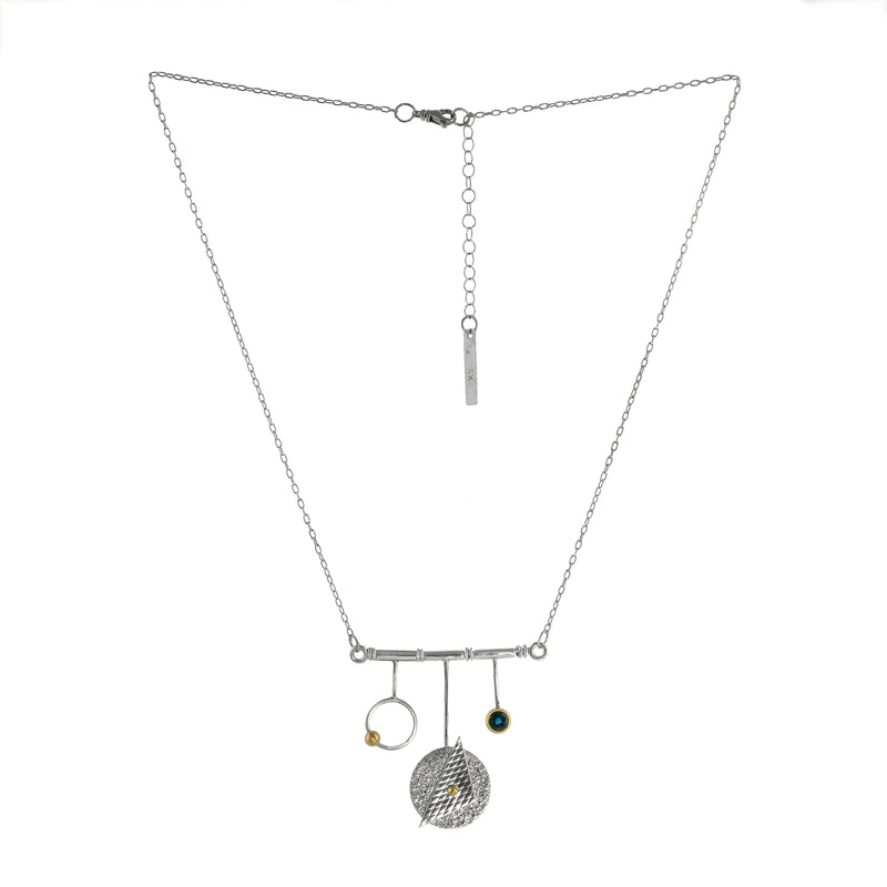 Modern geometric design pendant necklace, handcrafted from Argentium and sterling silver with 18K gold highlights and a London blue topaz set in an 18K gold bezel.