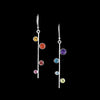 Asymmetrical, sterling silver earrings set with pride-themed faceted stones – pink tourmaline, red garnet, Mexican fire opal, golden citrine, green peridot, sky blue topaz, London blue topaz and purple amethyst.