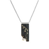One-of-a-kind pendant necklace featuring a pyrite slab on a sterling silver base and adorned with a white topaz set in 14k gold and additional 14k gold elements.