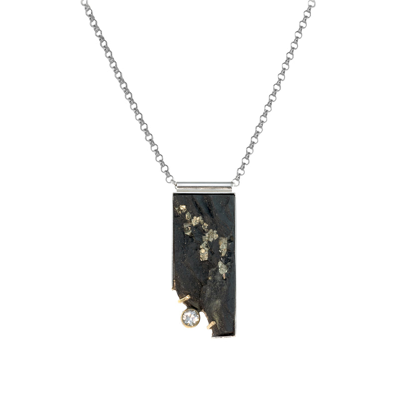 One-of-a-kind pendant necklace featuring a pyrite slab on a sterling silver base and adorned with a white topaz set in 14k gold and additional 14k gold elements.