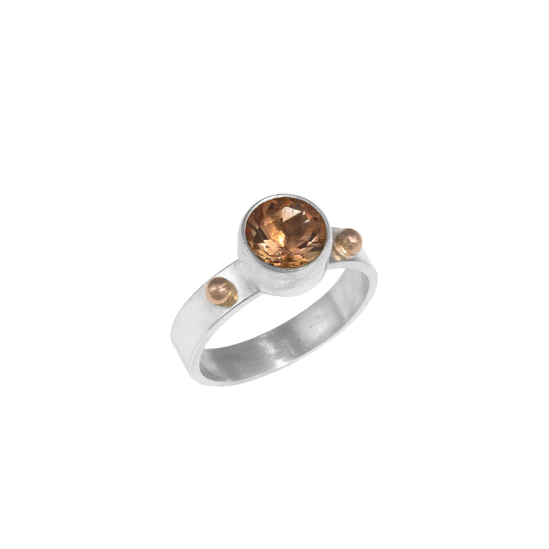 Sterling silver ring featuring an 8mm Oregon sunstone highlighted by 14k gold elements.