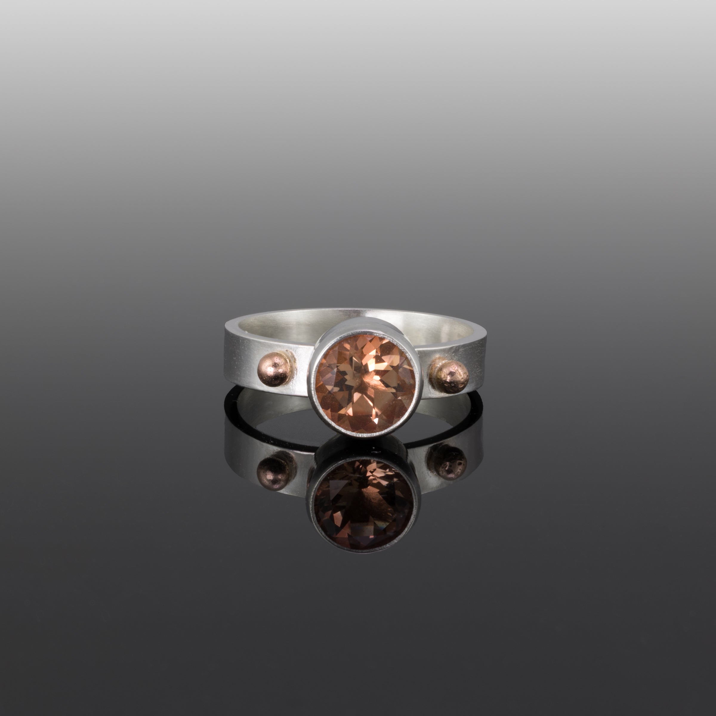 Sterling silver ring featuring an 8mm Oregon sunstone highlighted by 14k gold elements.