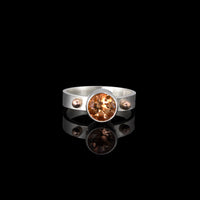 Sterling silver ring featuring an 8mm Oregon sunstone highlighted by 14k gold elements.