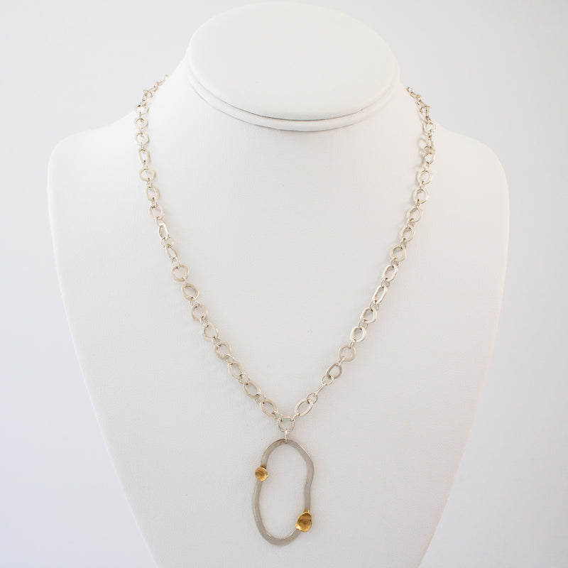 Modern design chain necklace with links individually hand-fabricated from Argentium sterling silver and 18K gold accents on the pendant.