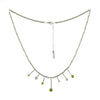 Contemporary design necklace, hand fabricated from Argentium sterling silver tubes and rings and set with four green peridots and three white topaz gemstones. 