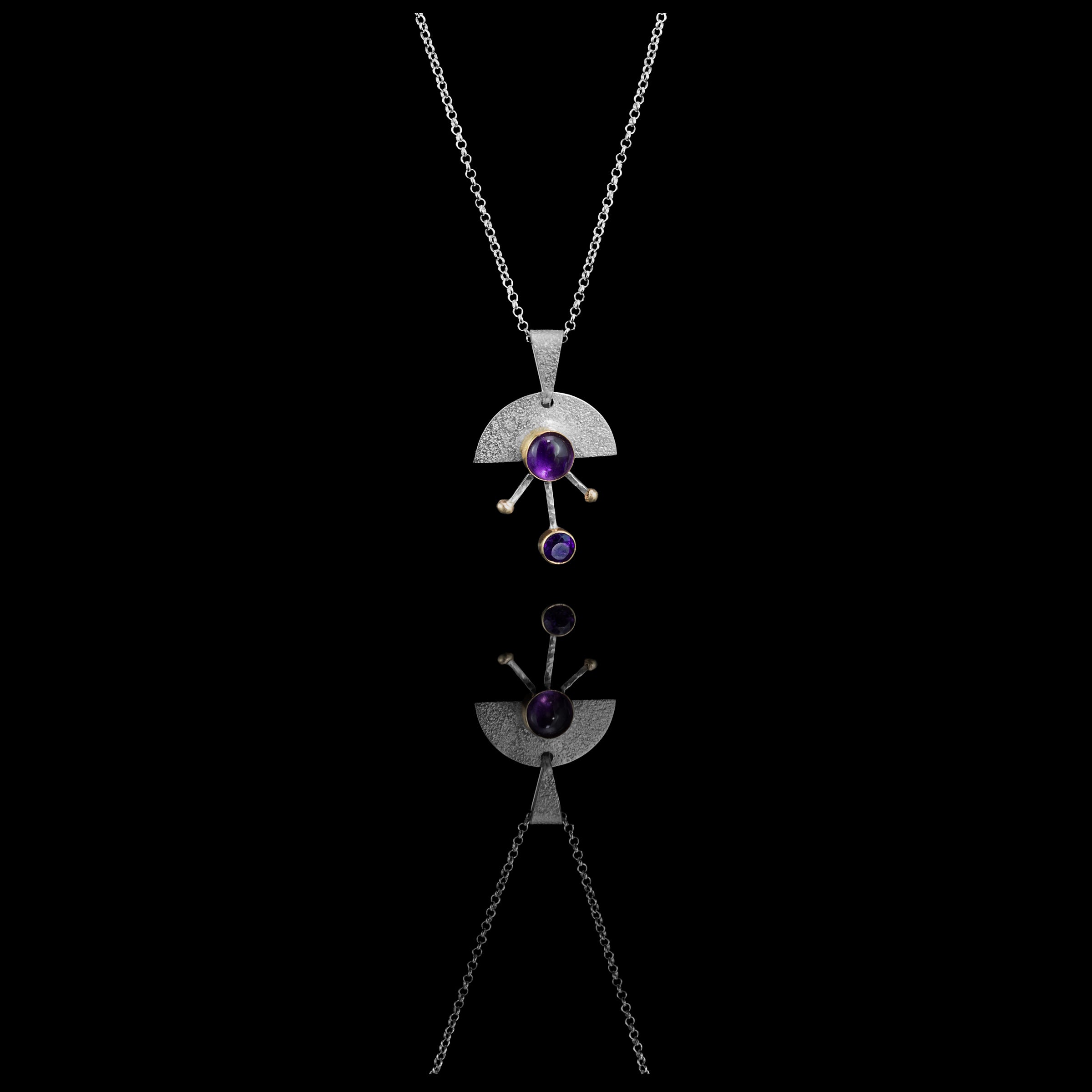 Contemporary sterling silver pendant necklace featuring a 8mm and 5mm purple amethysts set in 14k gold with additional 14K gold elements.  18” chain with 2” extender. 