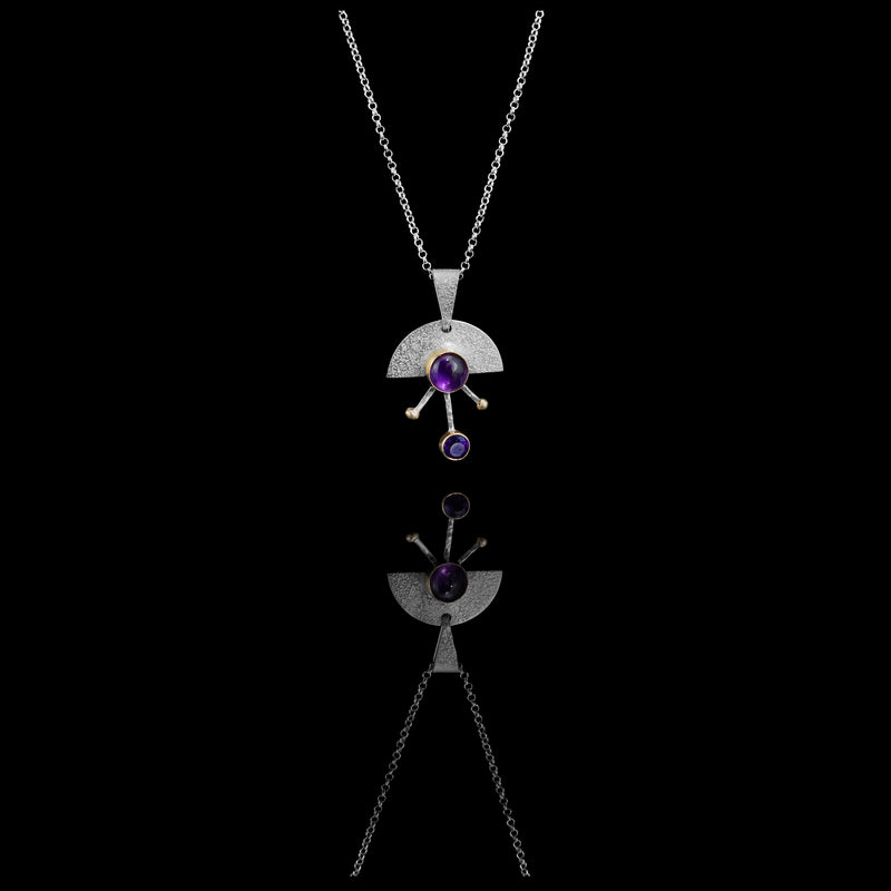 Contemporary sterling silver pendant necklace featuring a 8mm and 5mm purple amethysts set in 14k gold with additional 14K gold elements.  18” chain with 2” extender. 