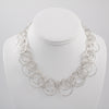 Statement necklace handcrafted from dozens of hammered rings of Argentium sterling silver.